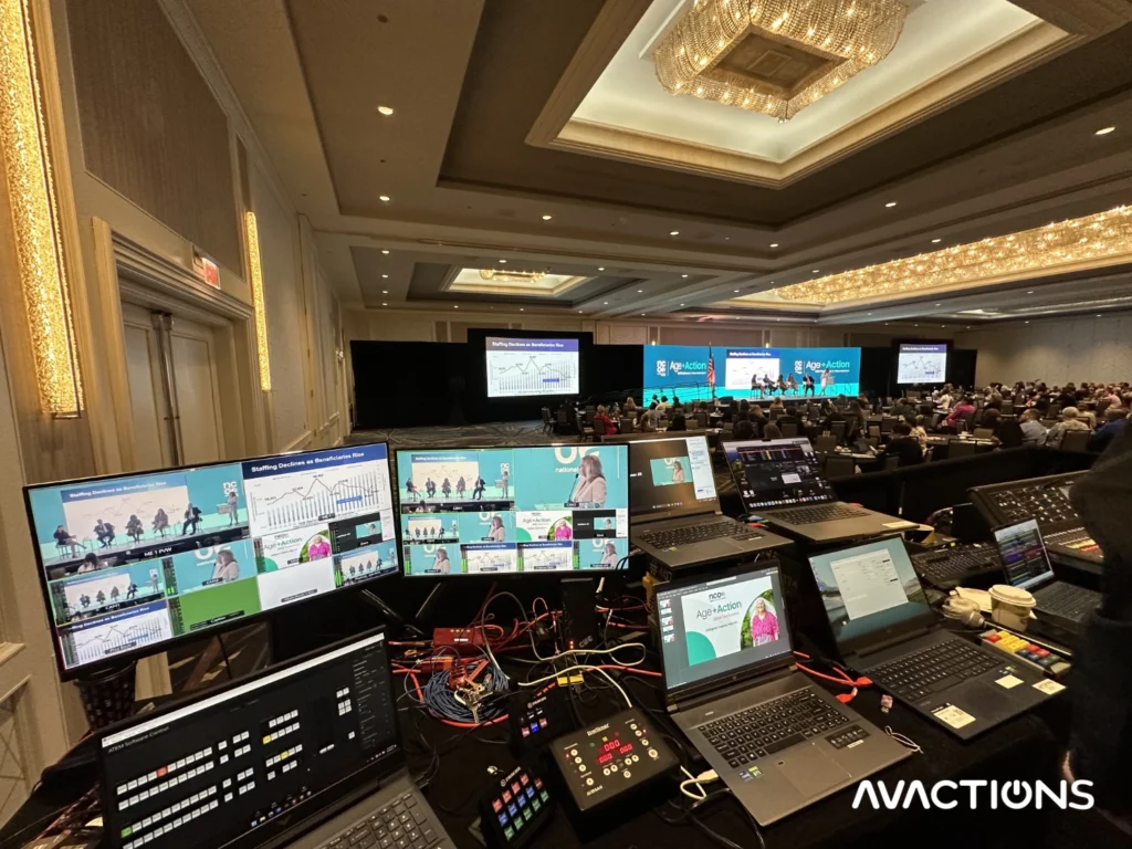Image of AV Actions working our turnkey solutions at the tech table for a corporate event